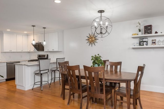 dining area featuring a chandelier and light wood-type flooring