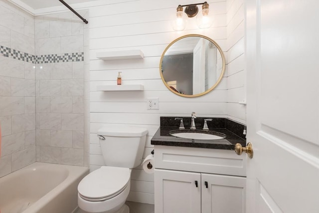 full bathroom with vanity, toilet, tiled shower / bath, and wooden walls