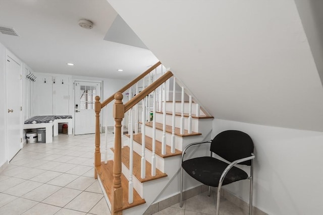 staircase featuring tile patterned floors