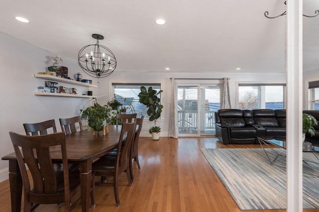 dining space featuring light hardwood / wood-style floors and a notable chandelier