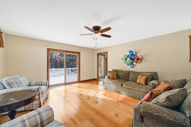 living room featuring light hardwood / wood-style floors and ceiling fan