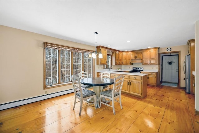 dining room with baseboard heating, an inviting chandelier, and light wood-type flooring