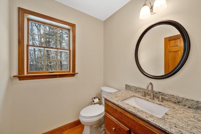 bathroom featuring toilet and vanity