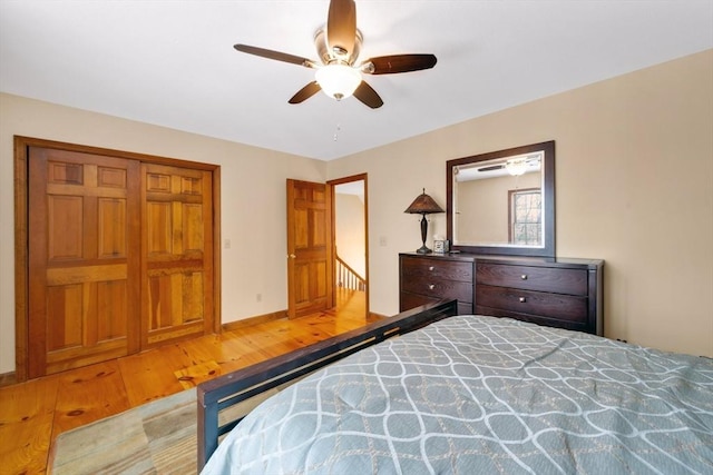 bedroom featuring wood-type flooring, a closet, and ceiling fan