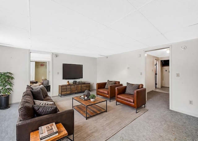 living room featuring a paneled ceiling and light carpet