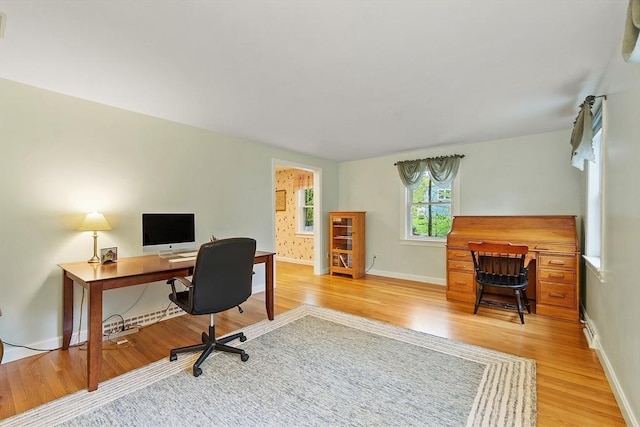 home office featuring light wood finished floors and baseboards