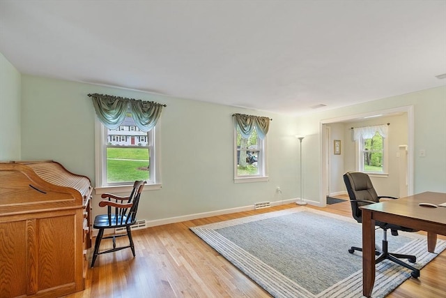 office space featuring light wood-type flooring and baseboards