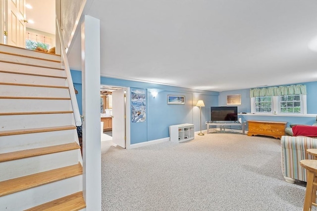 living room featuring carpet flooring, stairs, and baseboards