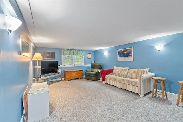 carpeted living area featuring baseboards