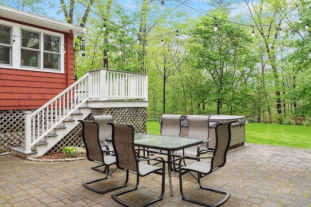 view of patio with outdoor dining space and stairs