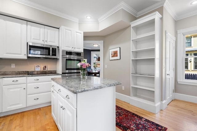 kitchen featuring stainless steel appliances, open shelves, baseboards, and light wood finished floors