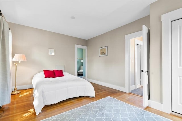 bedroom featuring baseboards and wood finished floors
