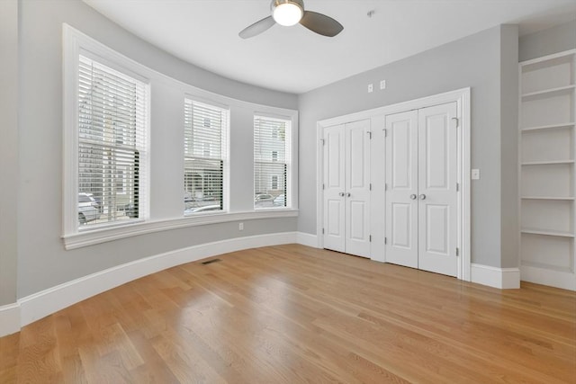 870 E 4th St Unit 1, Boston, MA 02127 - unfurnished bedroom featuring multiple closets, light wood-style flooring, and a ceiling fan