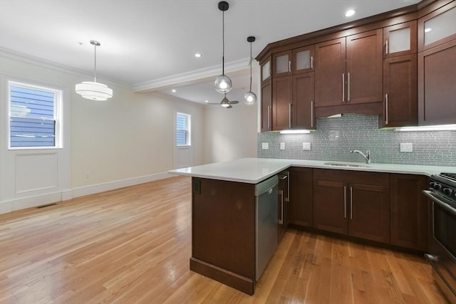 870 E 4th St Unit 1, Boston, MA 02127 - kitchen with a peninsula, appliances with stainless steel finishes, light wood finished floors, decorative backsplash, and crown molding