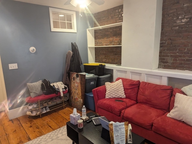 living room featuring wood-type flooring and ceiling fan