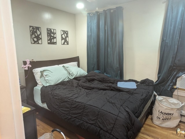 bedroom with hardwood / wood-style floors