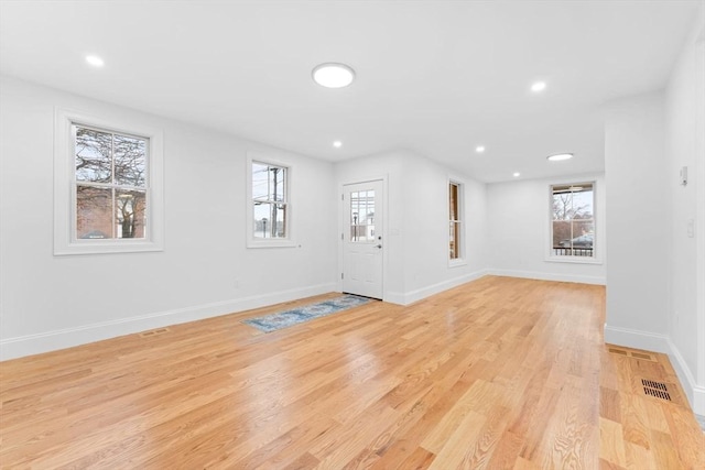 entryway featuring baseboards, recessed lighting, light wood-style flooring, and visible vents
