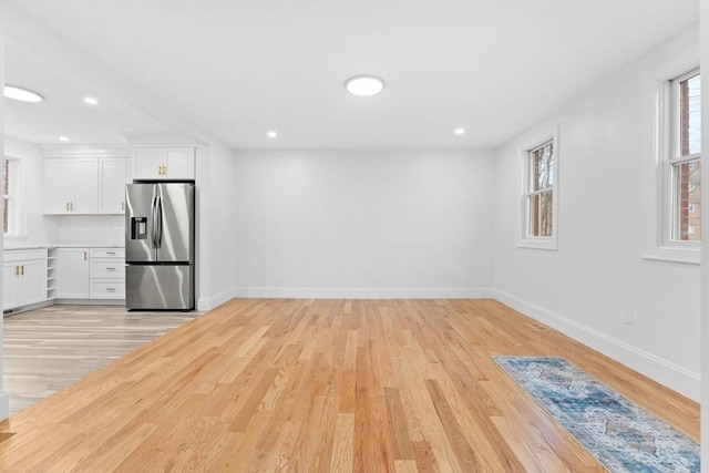 unfurnished living room featuring light wood-style floors, baseboards, and recessed lighting