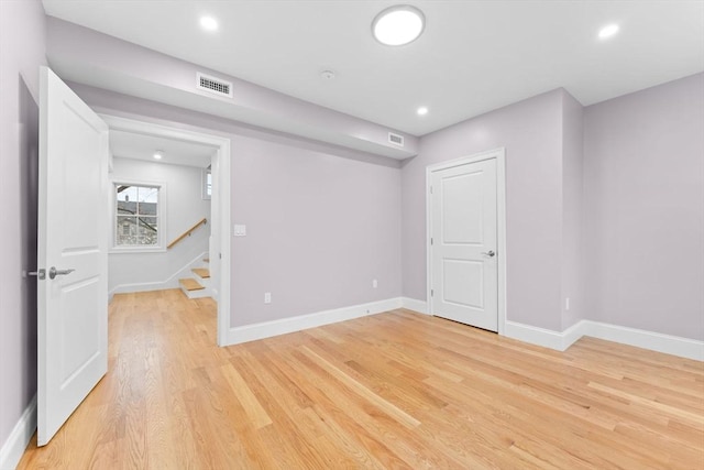 interior space featuring visible vents, baseboards, stairs, and light wood-type flooring