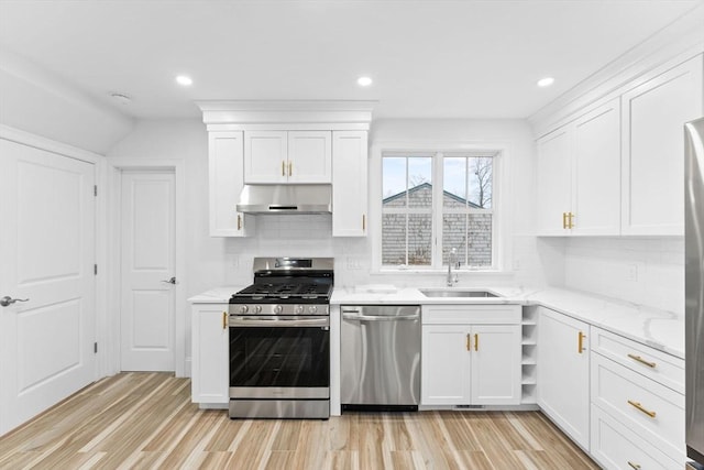 kitchen featuring a sink, white cabinets, stainless steel appliances, and under cabinet range hood