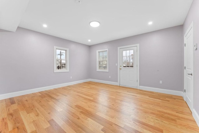 interior space featuring recessed lighting, baseboards, and light wood-style floors