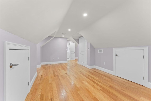 bonus room featuring recessed lighting, baseboards, vaulted ceiling, light wood-type flooring, and visible vents