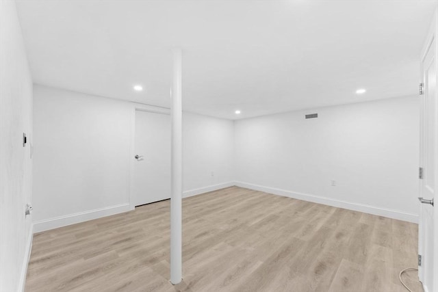 finished basement featuring recessed lighting, baseboards, and light wood-type flooring
