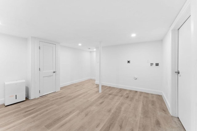 finished below grade area featuring recessed lighting, baseboards, and light wood finished floors