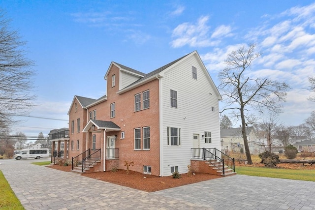 back of house featuring brick siding
