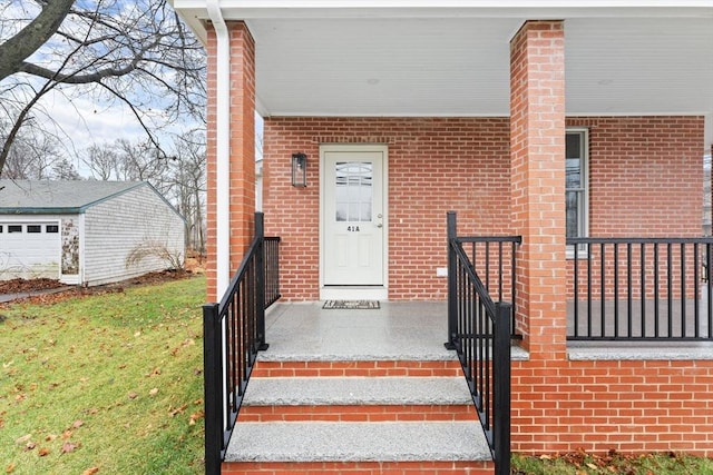 entrance to property with a yard and brick siding