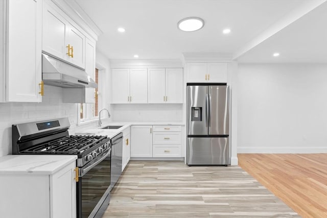 kitchen featuring a sink, stainless steel appliances, white cabinetry, and under cabinet range hood