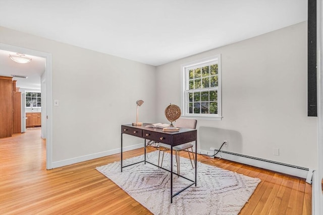 4 Fairway Rd, Acton, MA 01720 - home office with a baseboard heating unit, light wood-type flooring, and baseboards
