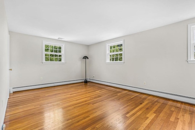 4 Fairway Rd, Acton, MA 01720 - empty room with wood finished floors, healthy amount of natural light, a baseboard heating unit, and a baseboard radiator