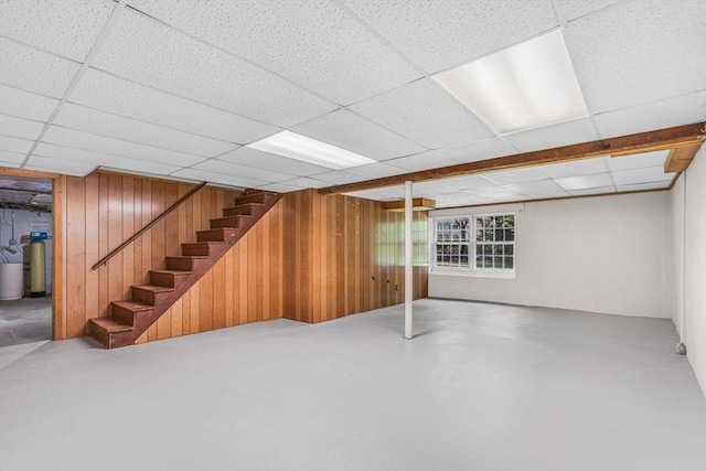 4 Fairway Rd, Acton, MA 01720 - below grade area featuring wood walls, a drop ceiling, a water softener, and stairs