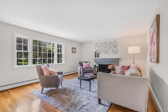 4 Fairway Rd, Acton, MA 01720 - living area with a fireplace, wood finished floors, a baseboard heating unit, and baseboard heating