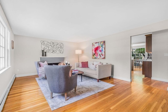 4 Fairway Rd, Acton, MA 01720 - living room featuring baseboard heating, light wood-style flooring, a fireplace, and baseboards