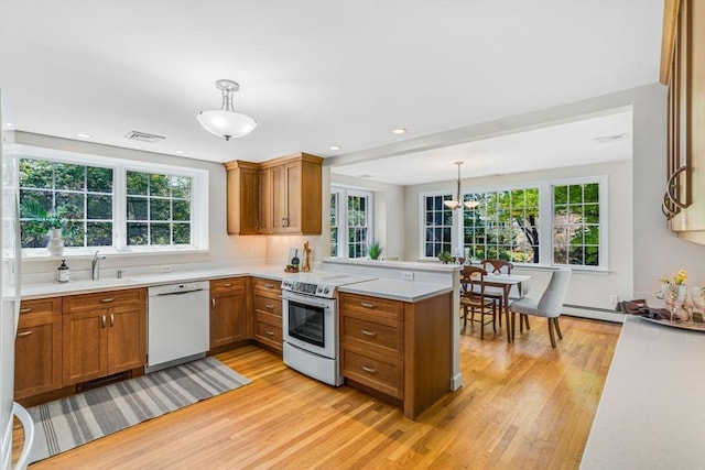 4 Fairway Rd, Acton, MA 01720 - kitchen featuring dishwasher, range with electric stovetop, brown cabinetry, light wood-style flooring, and recessed lighting