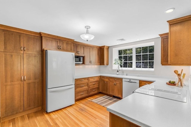 4 Fairway Rd, Acton, MA 01720 - kitchen featuring white appliances, light wood finished floors, brown cabinets, light countertops, and recessed lighting