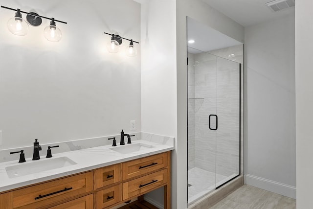 bathroom featuring hardwood / wood-style floors, vanity, and an enclosed shower