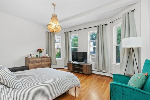 112 Thornton St Unit 2, Boston, MA 02119 - bedroom featuring wood finished floors, a baseboard heating unit, and a chandelier