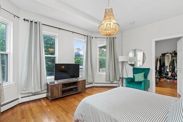 112 Thornton St Unit 2, Boston, MA 02119 - bedroom featuring a chandelier, baseboard heating, and wood finished floors