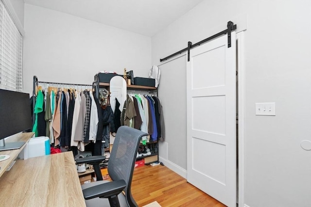 112 Thornton St Unit 2, Boston, MA 02119 - office area featuring a barn door, wood finished floors, and baseboards