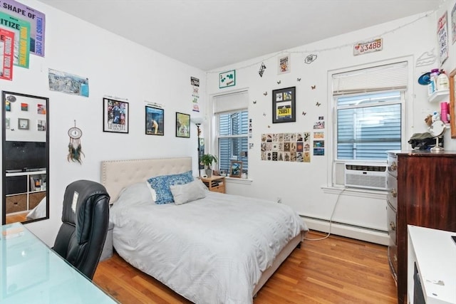 112 Thornton St Unit 2, Boston, MA 02119 - bedroom featuring a baseboard heating unit, light wood finished floors, and a desk