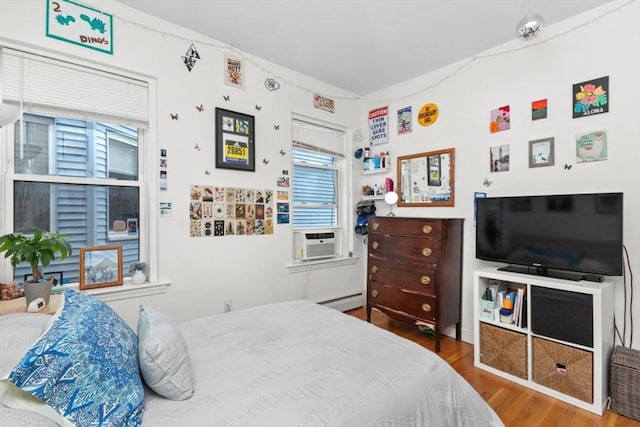 112 Thornton St Unit 2, Boston, MA 02119 - bedroom with wood finished floors, cooling unit, and baseboard heating