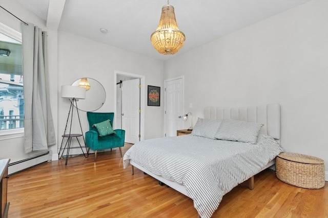 112 Thornton St Unit 2, Boston, MA 02119 - bedroom with baseboard heating, a chandelier, and wood finished floors