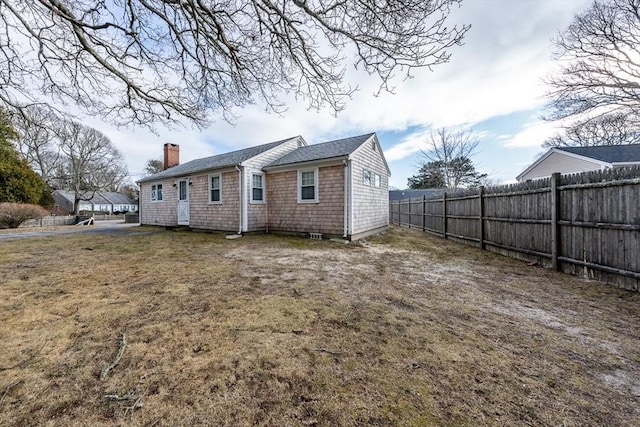 back of house featuring a yard