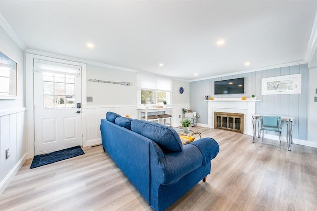 living room featuring ornamental molding and light wood-type flooring