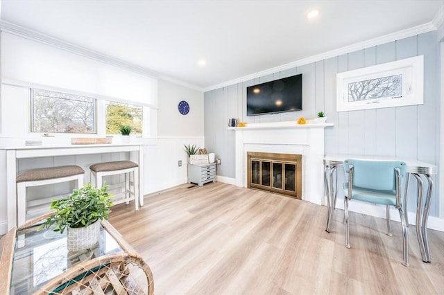 sitting room featuring light hardwood / wood-style flooring and ornamental molding