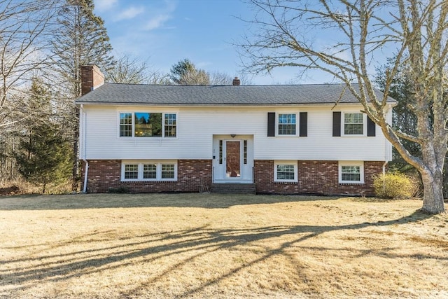 raised ranch with a front yard