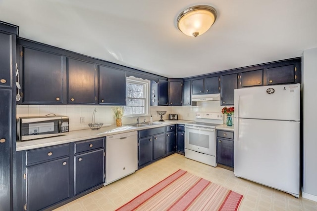 kitchen with tasteful backsplash, sink, and white appliances